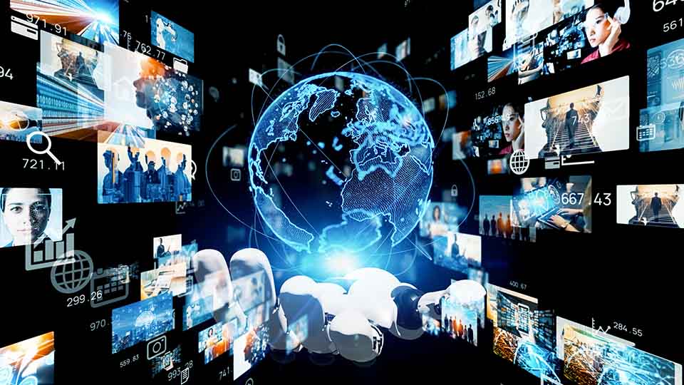 Robot hand holding hologram of planet earth and screens.