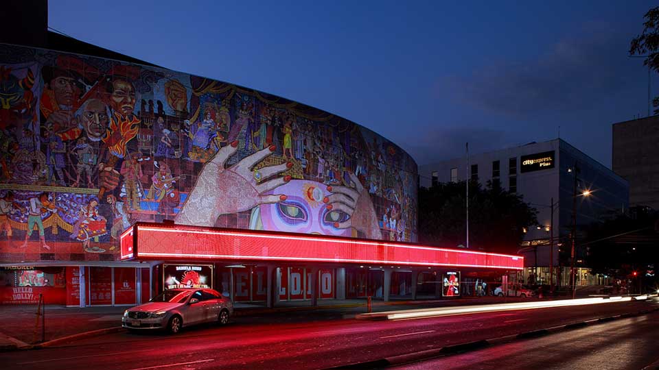 Night exterior view of theater and mural of mexican artist Diego Rivera