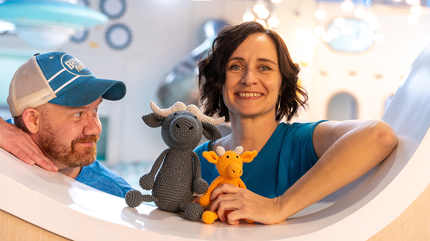 Monika Nowaczyk owner and founder of Cambodia Knits and Micheal McKay co-founder of Beebe+Bongo holding a grey knitted buffalo and an orange baby knitted buffalo