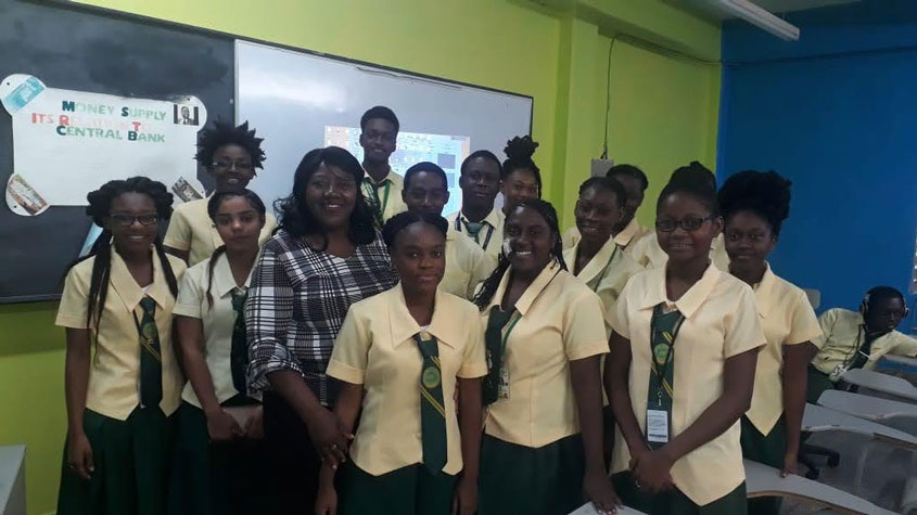 Rhona Jack with a group of high school kids in a classroom