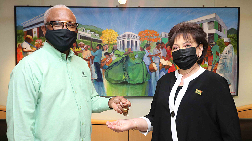  First Citizens Chairman Anthony Smart (left) hands over the keys to the Penny Bank building to Rosalind Gabriel, Director of the Trinidad and Tobago Carnival Museum (right) in 2021