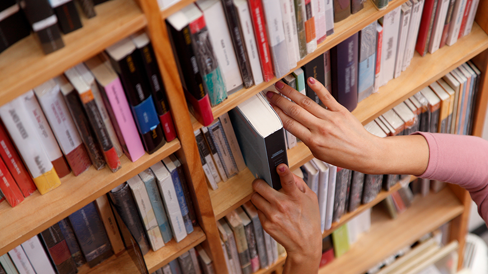 Person selecting books in a bookstore