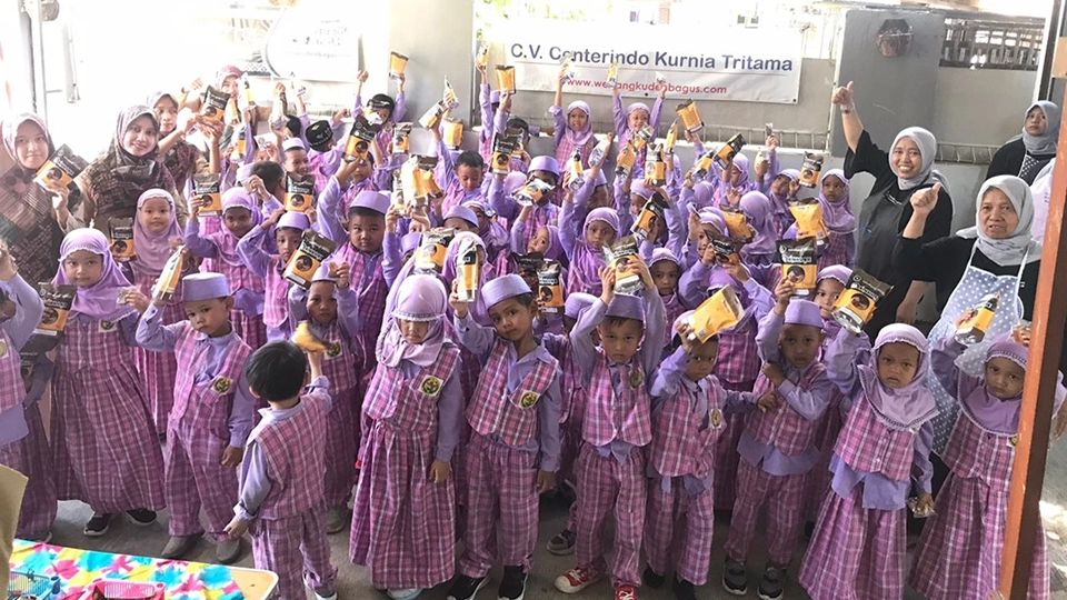 Young children of Yogyakarta posing with their jamu botanical drinks