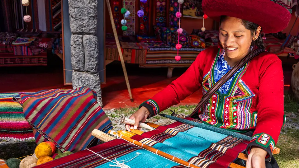 Peruvian woman weaving in Chinchero The Sacred