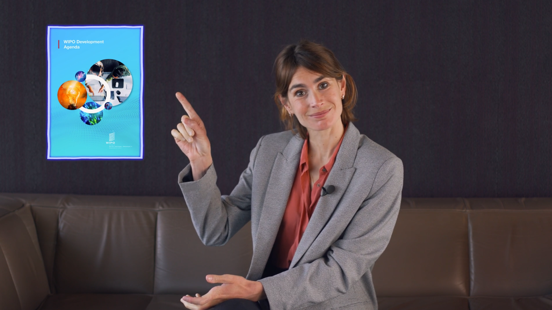 Video poster of a woman pointing at a Development Agenda publication